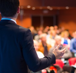 A man speaking to an audience A man speaking to an audience